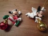 3 christmas ornaments of mickey, mini and pluto holding a christmas ball 